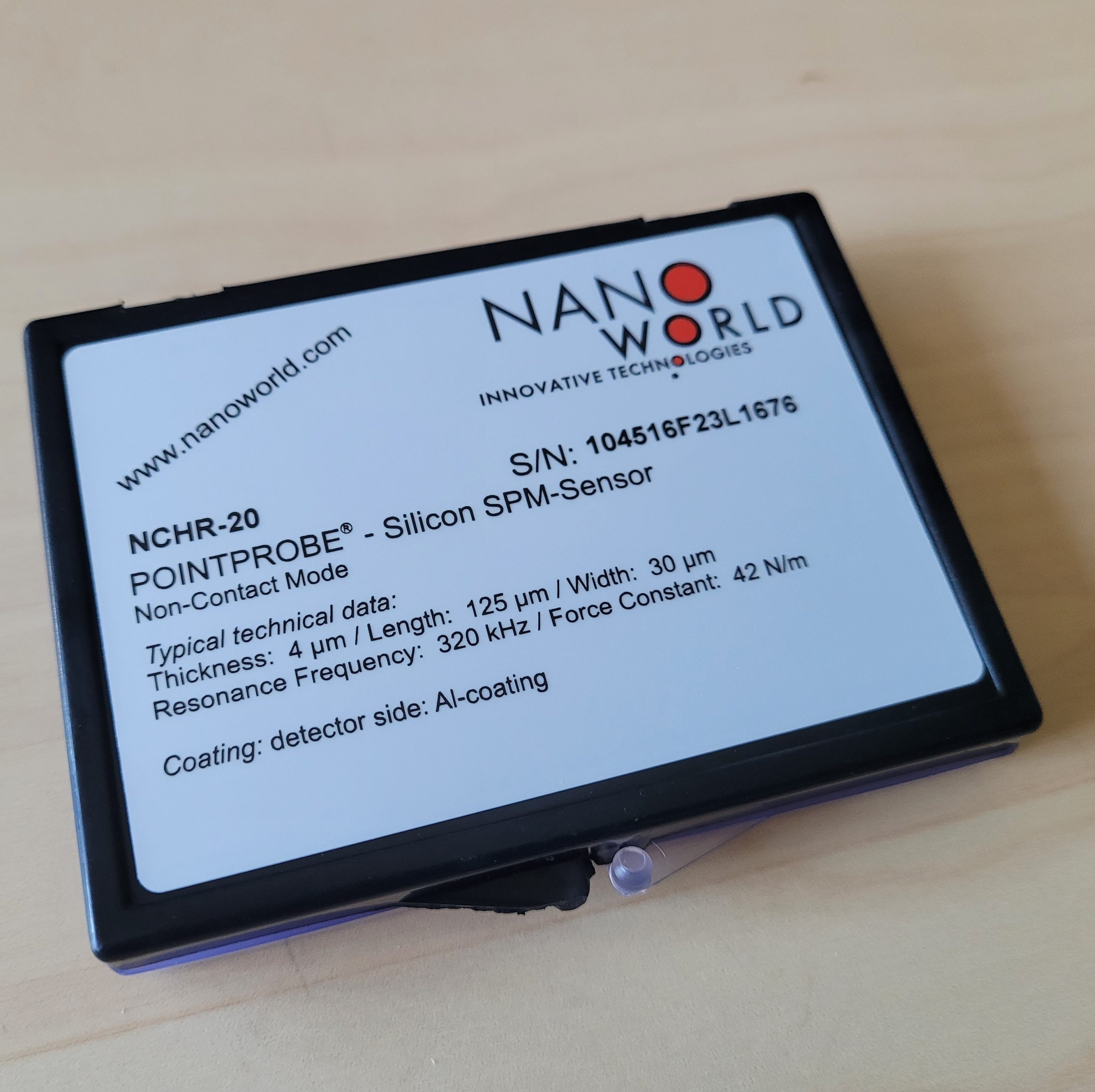 Current NanoWorld AFM probe product label showing the nominal resonant frequency and nominal force constant.